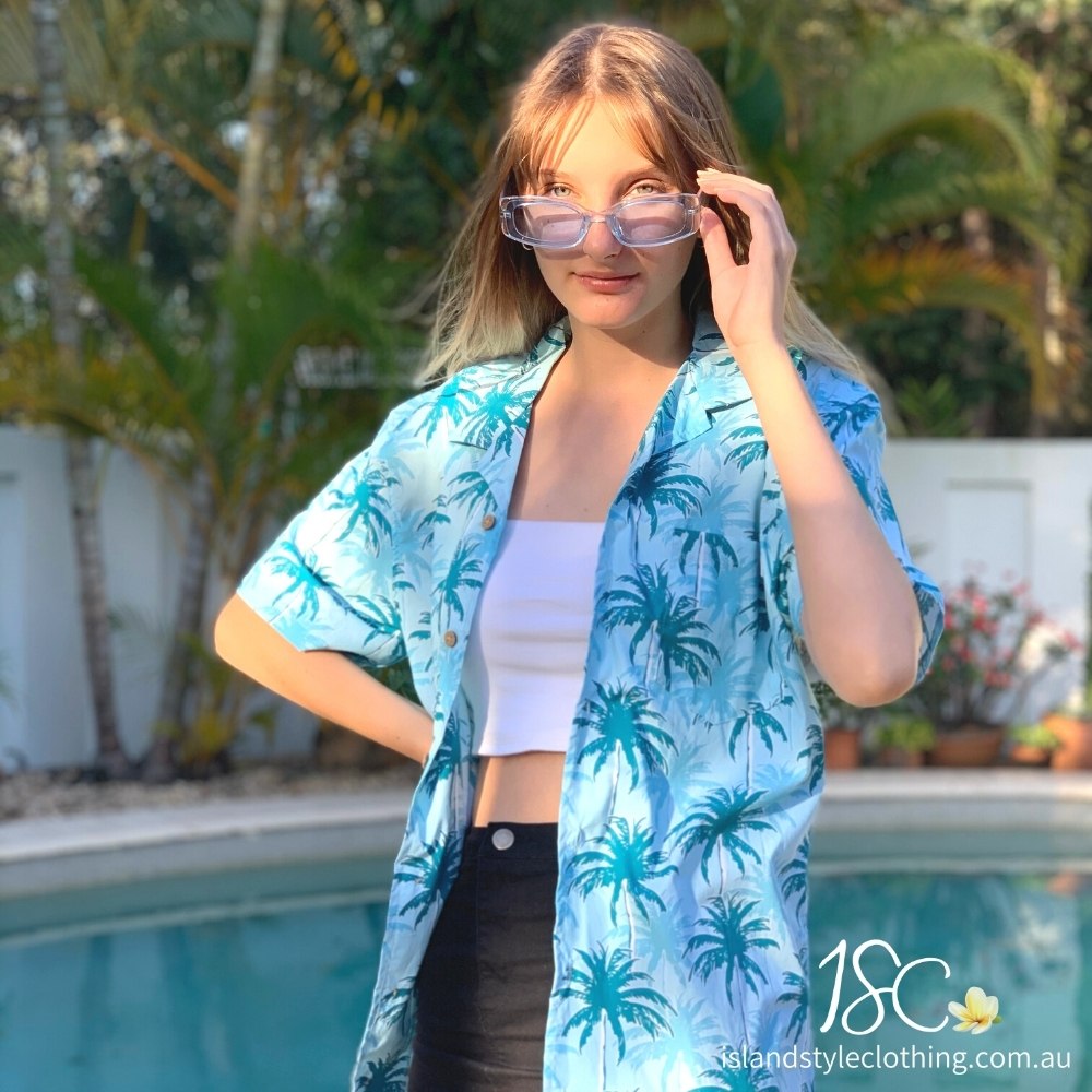 Let yourself feel the island vibes with this unique blue aloha shirt. The classic Hawaiian pattern with palm trees will have you feeling like a beachcomber even in corporate headquarters!  100% cotton ensures a comfortable fit for all day wear, whether you’re heading out on a cruise or to the office. It's truly a shirt "to-tally" worth getting your hands on!