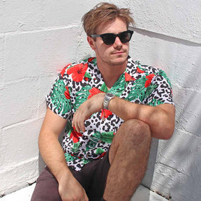 Looking for a stylish and eye-catching shirt for your next festival? Check out the Party Animal Mens Shirt in leopard print with vibrant hibiscus flowers and monstera leaves! This shirt is sure to make you stand out in the crowd with its bold and fun design.  The lightweight and breathable material ensures you stay comfortable in warm weather, while the relaxed fit allows for easy movement while dancing or socialising.
