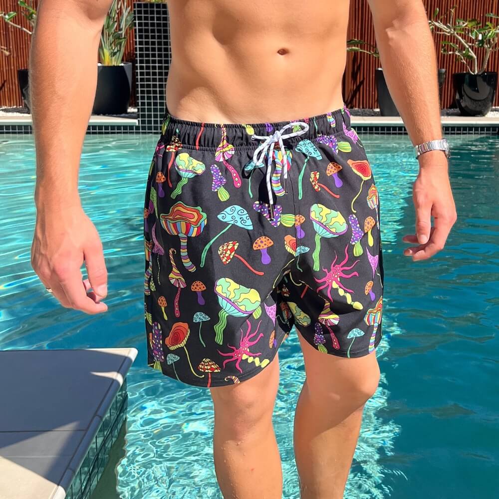 a man standing next to a swimming pool