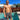 a shirtless man standing in front of a swimming pool