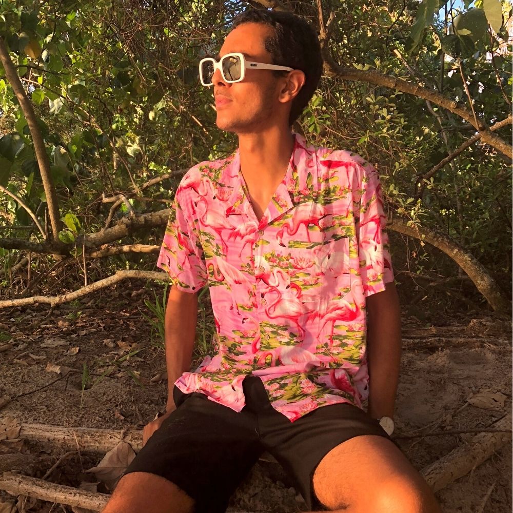 This classic men's Hawaiian shirt features vibrant pink flamingos printed on 100% rayon fabric. Complete with coconut buttons, it's perfect for a stylish yet comfortable island-style look. Steal the spotlight everywhere you go.
