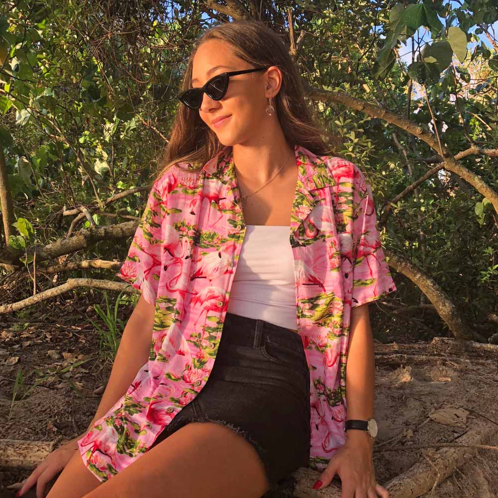 This Pink Flamingo Women's Hawaiian Shirt will let you capture tropical vibes with a bright pink base and a cheerful flamingo print. Crafted from 100% soft rayon, this shirt is a great choice for any day of the week, perfect for Aloha Fridays.